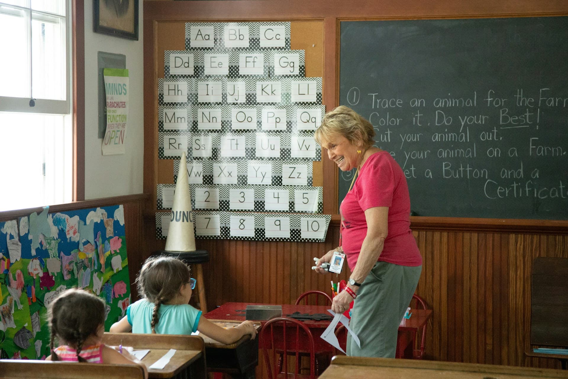 teacher in front of elementary school classroom