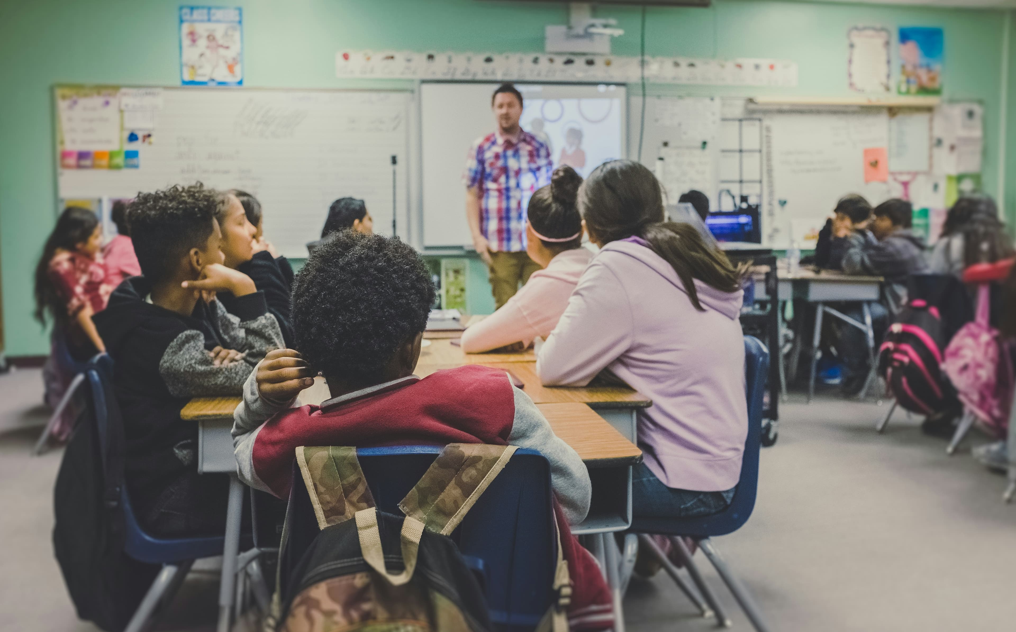 teacher in front of middle school students in a classroom