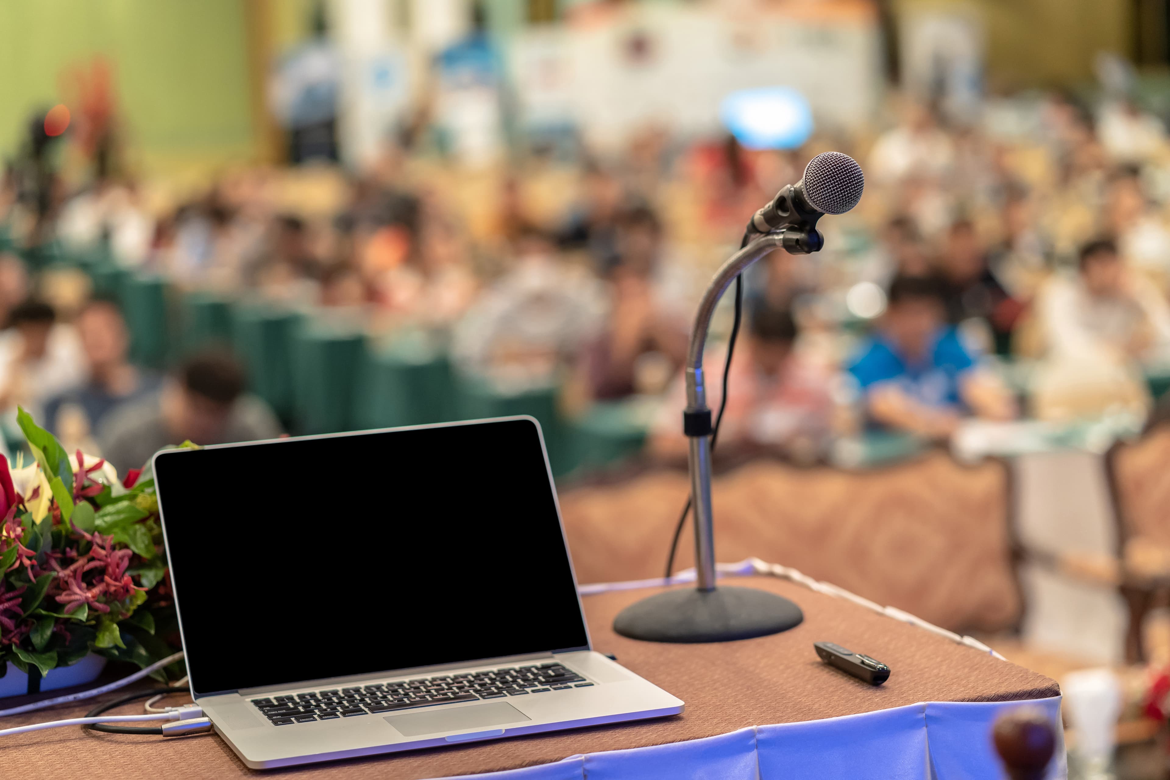 Laptop, podium, and microphone prepared for speaking event